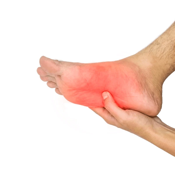person holding bottom of foot showing burning or tingling nerve pain
