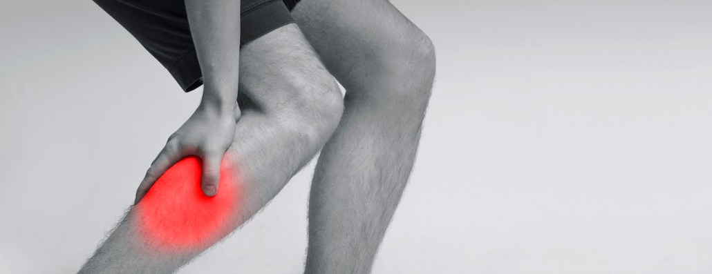 person holding calf due to leg pain
