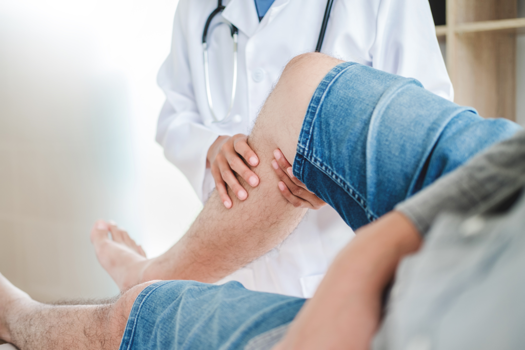 doctor examining patient leg while discussing treatment options