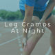 Person experiencing painful calf muscle cramp in the leg at night