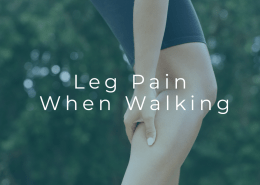 Person experiencing leg pain while walking outdoors