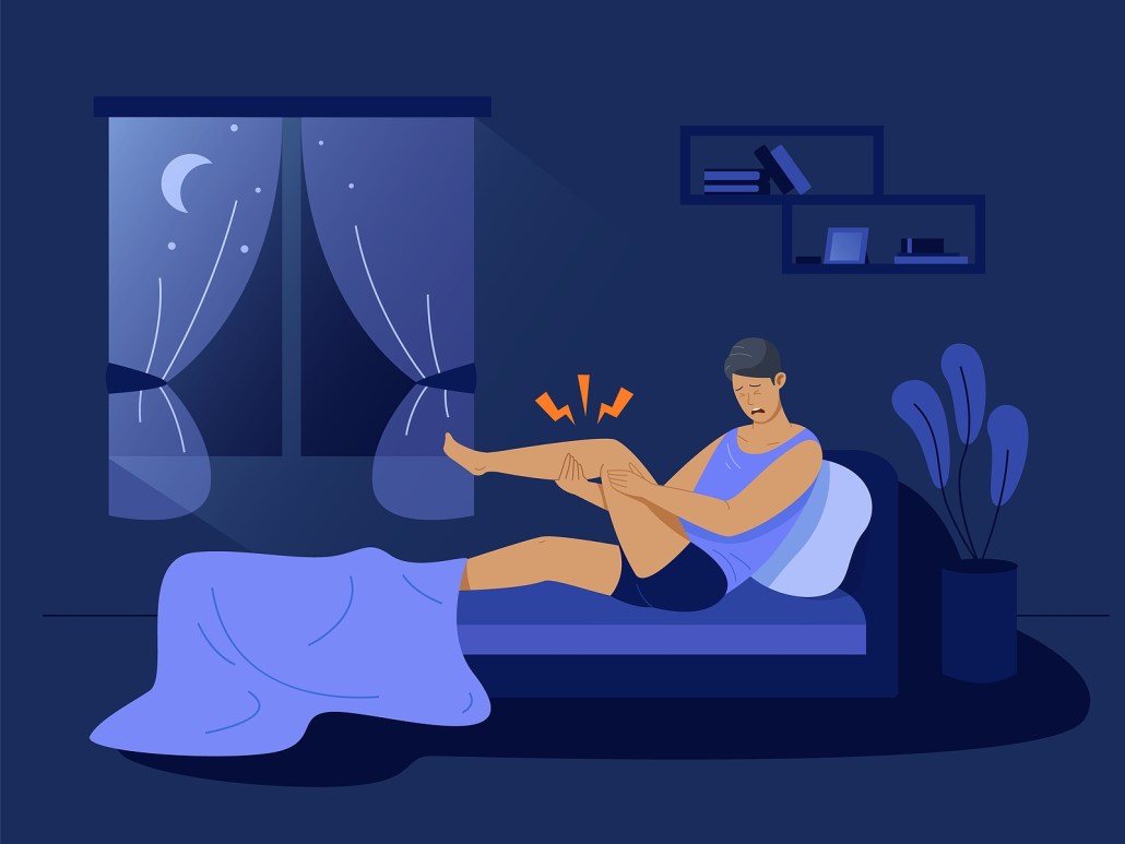 person experiencing painful leg cramps at night in bed